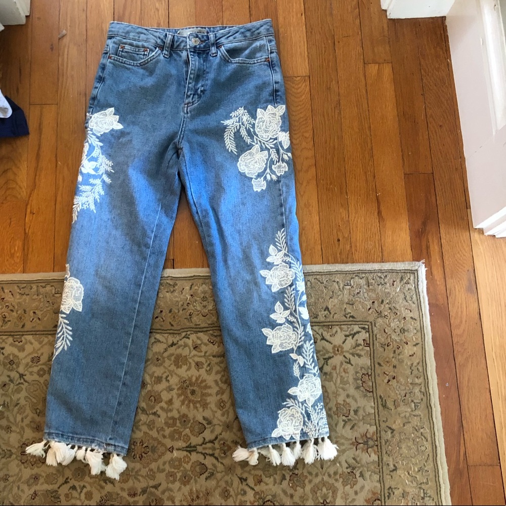 Blue mom jeans with white flowered embroidery